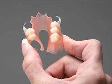 Partial dentures types comparison chart 2025 showing acrylic, cast-metal, and flexible options with costs and pros and cons